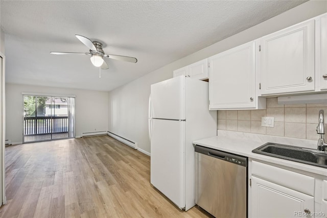 7020 E Girard Ave Unit 109, Denver, CO 80224 - kitchen with dishwasher, freestanding refrigerator, white cabinetry, a baseboard radiator, and ceiling fan