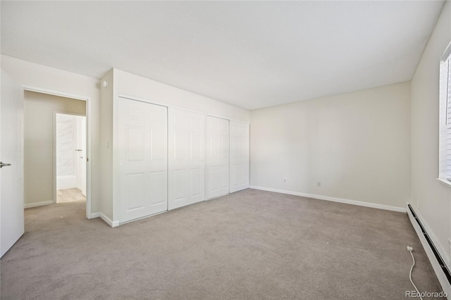 7020 E Girard Ave Unit 109, Denver, CO 80224 - unfurnished bedroom with a baseboard radiator, carpet, and a closet