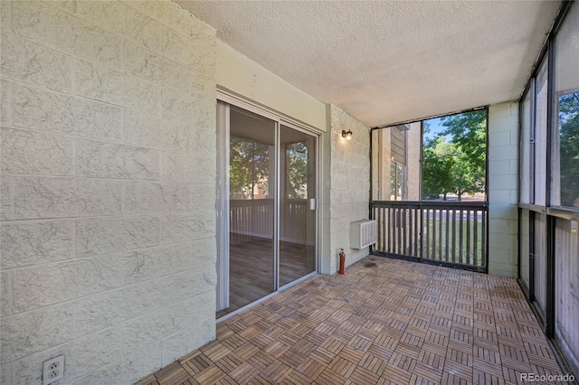 7020 E Girard Ave Unit 109, Denver, CO 80224 - unfurnished sunroom with healthy amount of natural light and an AC wall unit
