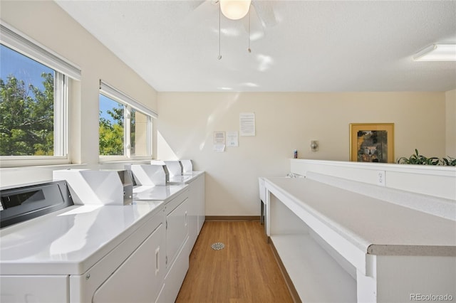 7020 E Girard Ave Unit 109, Denver, CO 80224 - community laundry with washing machine and clothes dryer, light wood-style floors, and ceiling fan