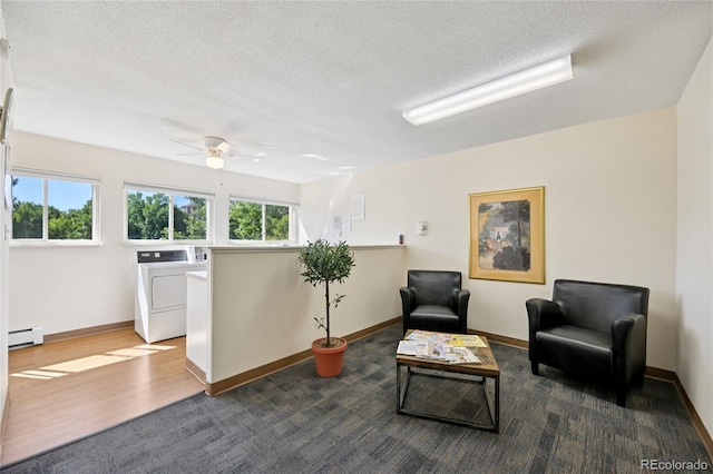 7020 E Girard Ave Unit 109, Denver, CO 80224 - sitting room with a baseboard radiator, ceiling fan, independent washer and dryer, a textured ceiling, and wood finished floors