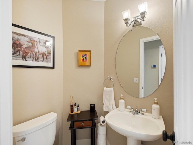 bathroom featuring sink and toilet