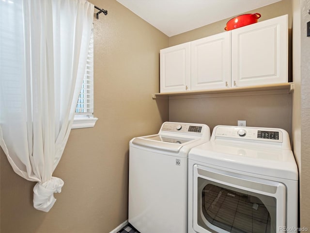 laundry room featuring independent washer and dryer and cabinets