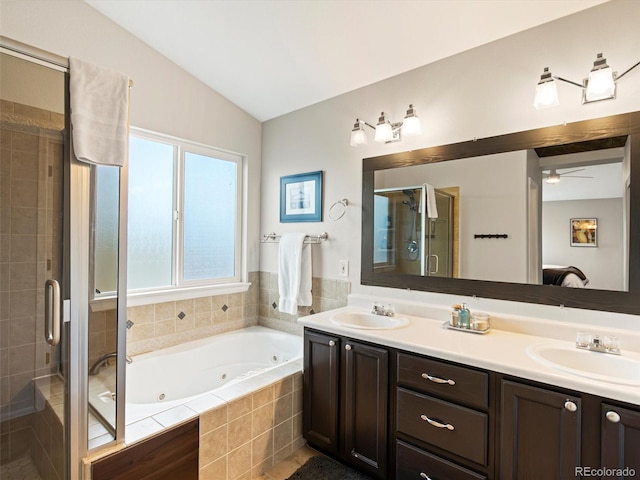 bathroom featuring separate shower and tub, vanity, and lofted ceiling