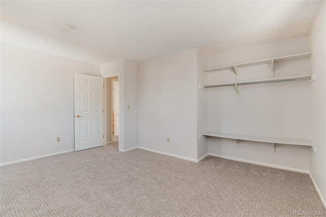 unfurnished bedroom featuring a textured ceiling, baseboards, and carpet floors