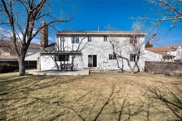 rear view of property with a patio area, a lawn, and fence