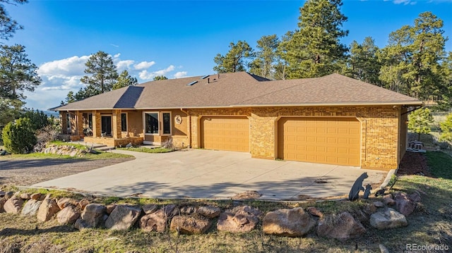 17675 State Highway 83, Colorado Springs, CO 80908 - ranch-style house featuring a garage, driveway, brick siding, and roof with shingles