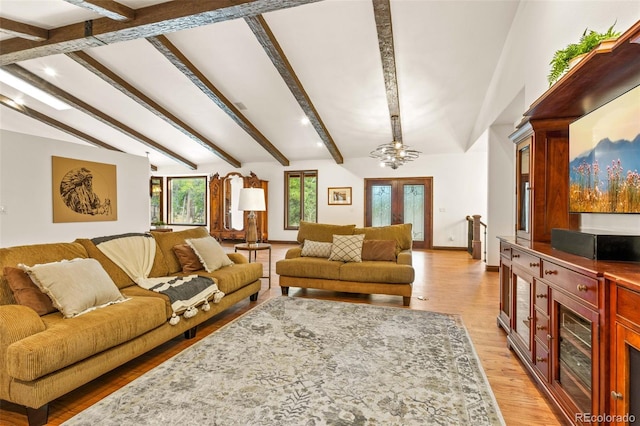 living room with lofted ceiling with beams, light wood-type flooring, and ceiling fan