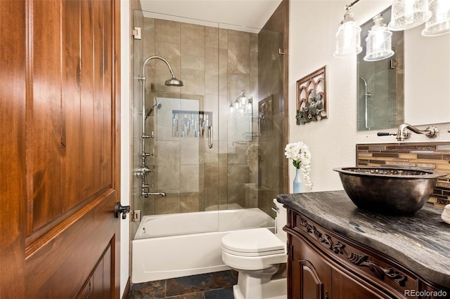 full bathroom with tile patterned floors, vanity, bath / shower combo with glass door, and toilet