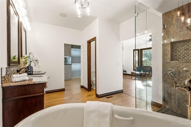 17675 State Highway 83, Colorado Springs, CO 80908 - full bath featuring a tub, wood finished floors, and vanity