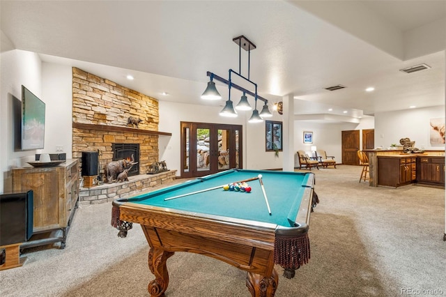 rec room featuring light colored carpet, a stone fireplace, french doors, and billiards