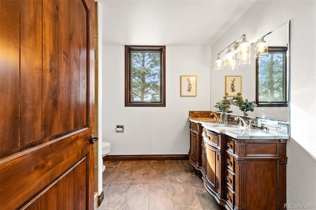 bathroom featuring tile patterned flooring, toilet, and vanity