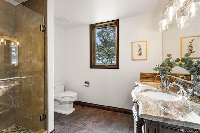 bathroom featuring walk in shower, double sink vanity, and toilet