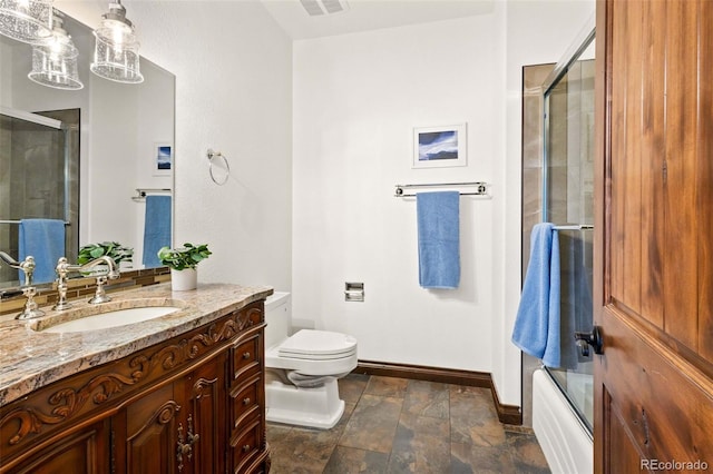 full bathroom with tile patterned floors, vanity, bath / shower combo with glass door, and toilet