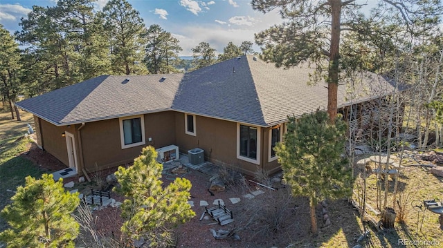 17675 State Highway 83, Colorado Springs, CO 80908 - rear view of property with a shingled roof and stucco siding