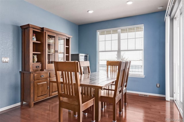 dining space with dark wood-type flooring