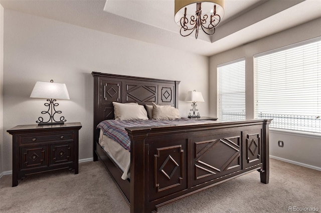 carpeted bedroom with an inviting chandelier