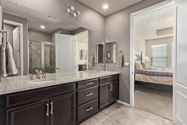 bathroom featuring walk in shower, vanity, a textured ceiling, and tile patterned floors