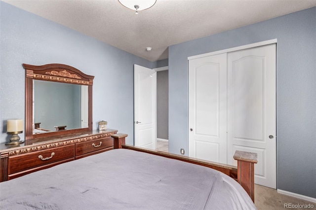 bedroom featuring a closet, a textured ceiling, and light colored carpet