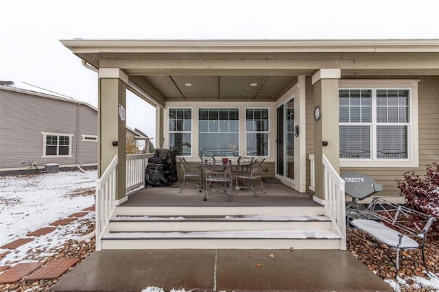 snow covered deck with central air condition unit