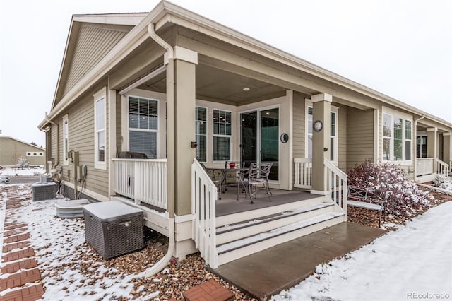 snow covered property featuring central air condition unit