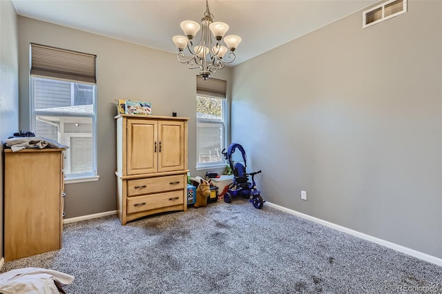 misc room with a notable chandelier and carpet