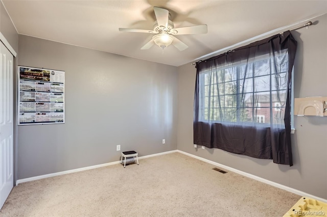 empty room with carpet and ceiling fan