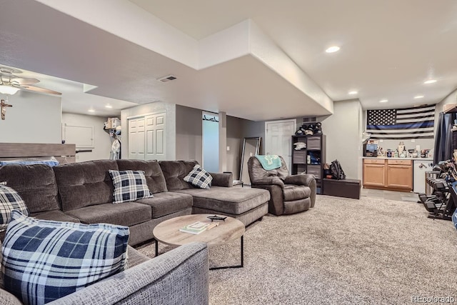 living room with light colored carpet and ceiling fan