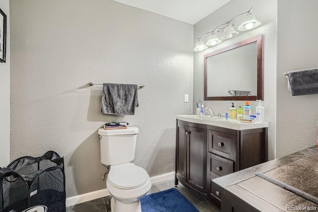 bathroom with vanity, toilet, and tile patterned floors