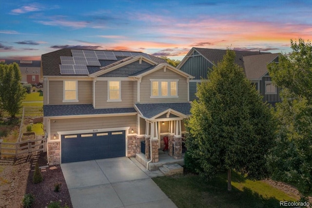 3115 Bryce Dr, Fort Collins, CO 80525 - craftsman inspired home with solar panels, concrete driveway, a garage, stone siding, and a shingled roof