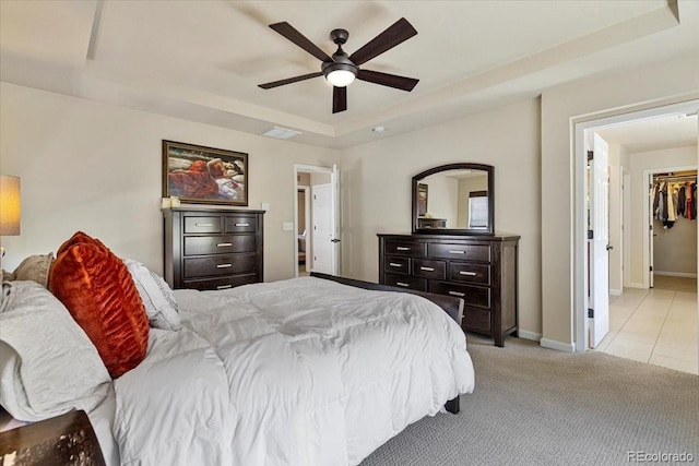 3115 Bryce Dr, Fort Collins, CO 80525 - bedroom with a raised ceiling, light carpet, ceiling fan, and light tile patterned flooring
