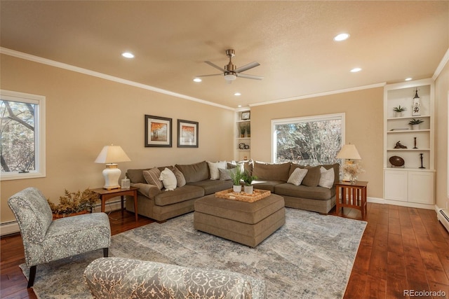 living room with dark wood-type flooring, built in shelves, and a wealth of natural light