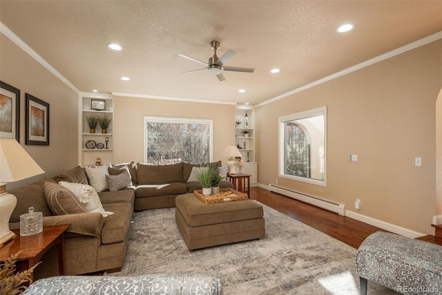 living room with crown molding, a textured ceiling, a baseboard radiator, and wood-type flooring