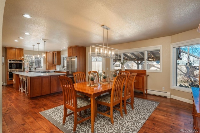 dining room with a baseboard radiator, dark hardwood / wood-style flooring, a textured ceiling, and a notable chandelier