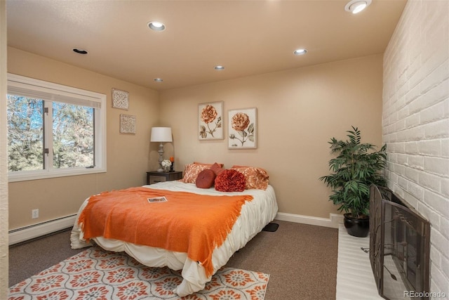 bedroom with a fireplace and a baseboard heating unit