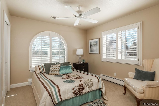 bedroom featuring ceiling fan, light carpet, and baseboard heating