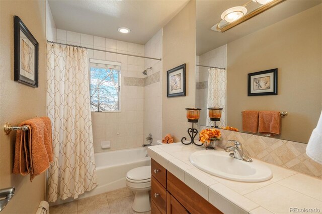 full bathroom featuring shower / tub combo, a baseboard heating unit, vanity, tile patterned floors, and toilet