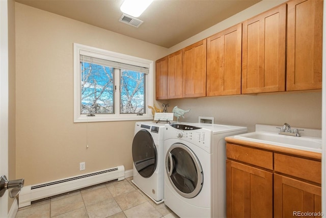 laundry room featuring washer and dryer, a baseboard radiator, sink, cabinets, and light tile patterned floors