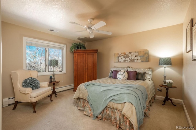 carpeted bedroom featuring baseboard heating, ceiling fan, and a textured ceiling