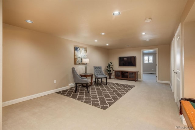 sitting room featuring a baseboard radiator and carpet flooring