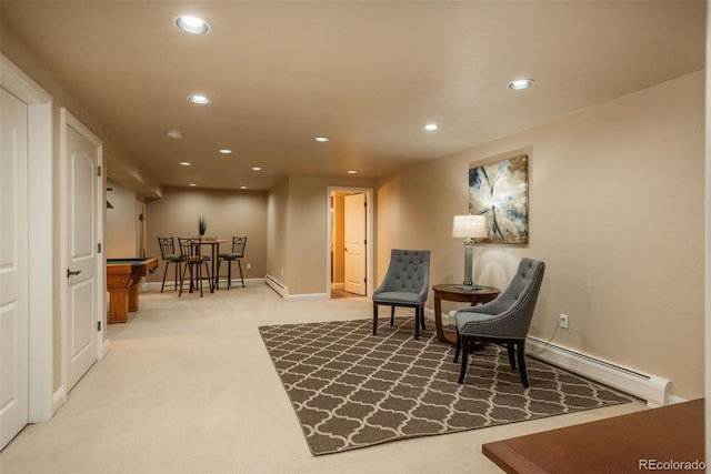 sitting room featuring carpet flooring and a baseboard heating unit