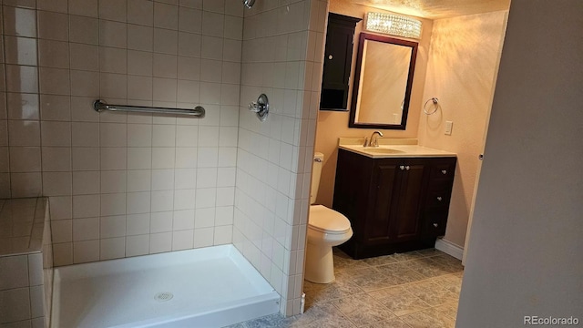 bathroom featuring baseboards, a shower stall, toilet, and vanity