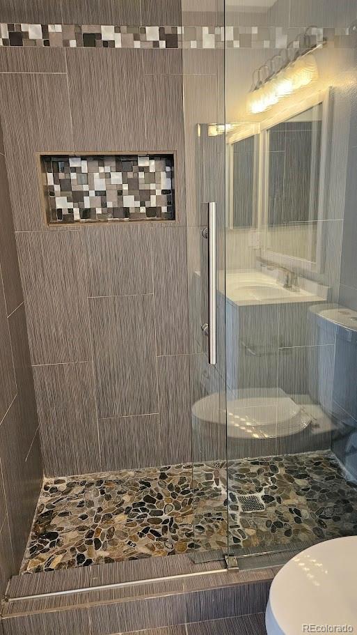 full bath featuring toilet and a stall shower