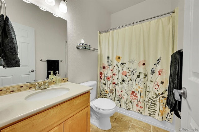 bathroom with a shower with curtain, vanity, toilet, and tile patterned floors