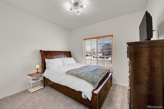 bedroom featuring light carpet and baseboards