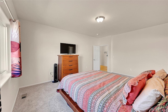 carpeted bedroom featuring visible vents and baseboards