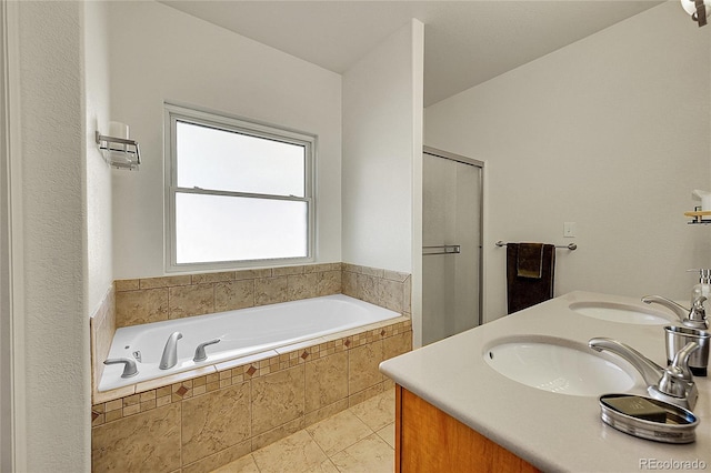 full bath with a stall shower, tile patterned flooring, a garden tub, and a sink