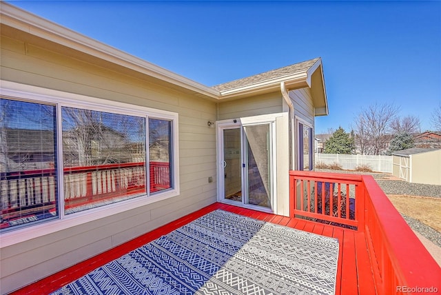 wooden deck with fence and an outdoor structure