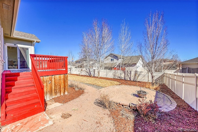 view of yard featuring a patio area, a fenced backyard, a residential view, and a wooden deck