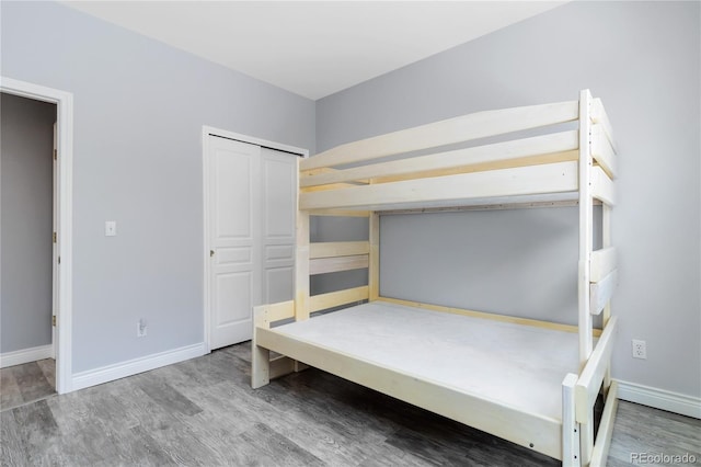 unfurnished bedroom featuring baseboards and wood finished floors